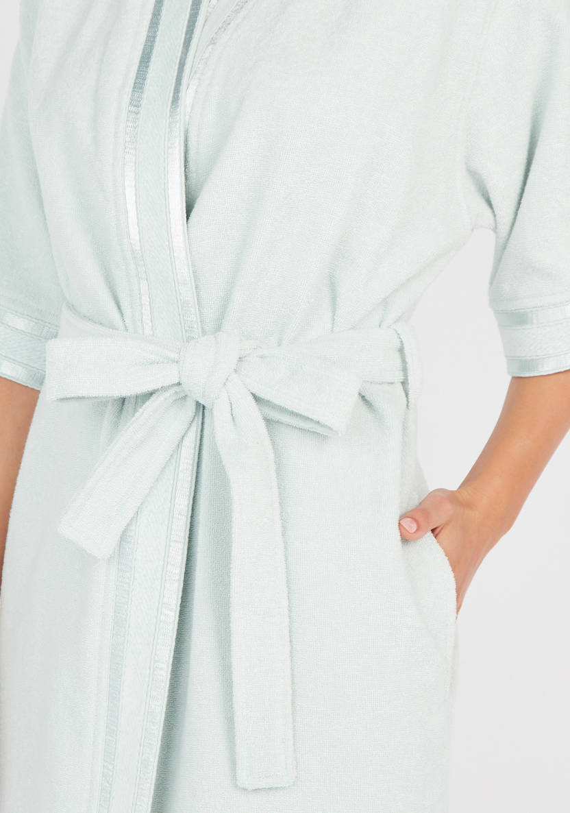 Textured swimsuit with 3/4 sleeves and tie details