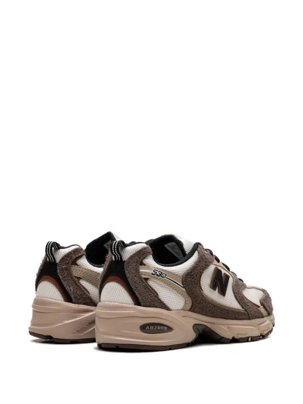 New Balance 530 trainers in white and brown
